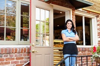 Woman standing outside bakery/café